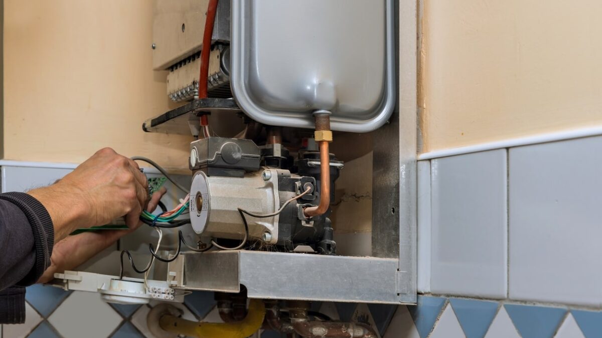 Technician repairing the internal components of a 40-Gallon Water Heater.
