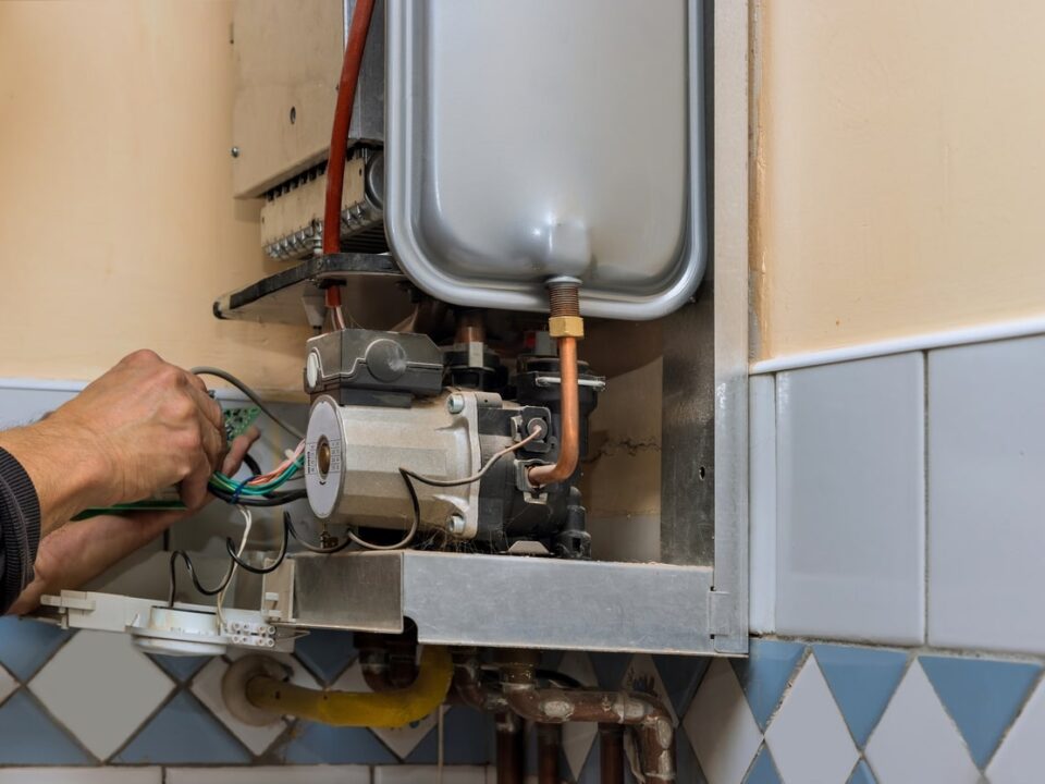Technician repairing the internal components of a 40-Gallon Water Heater.
