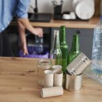 Recycling assorted household waste on a wooden table with noisy garbage disposals humming in the background.